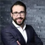 Man standing in front of brick wall